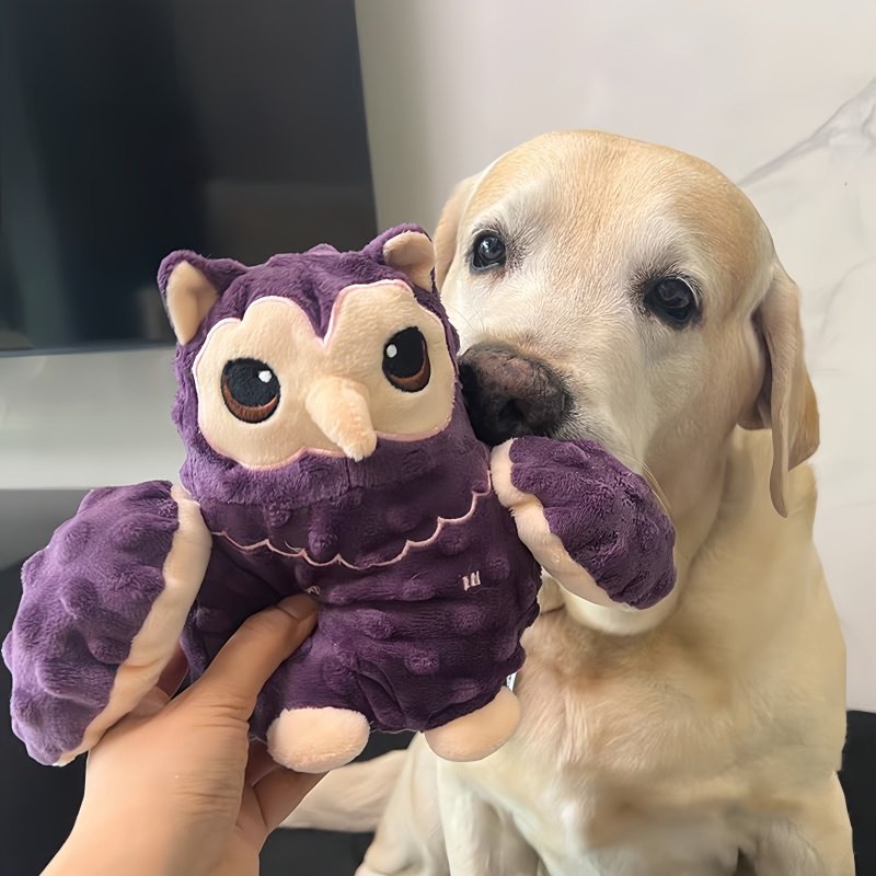 Dog examining a purple owl plush pet toy